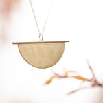 Afbeelding in Gallery-weergave laden, Pendant in brass and silver ~ brass half circle on silver line    (made to order)
